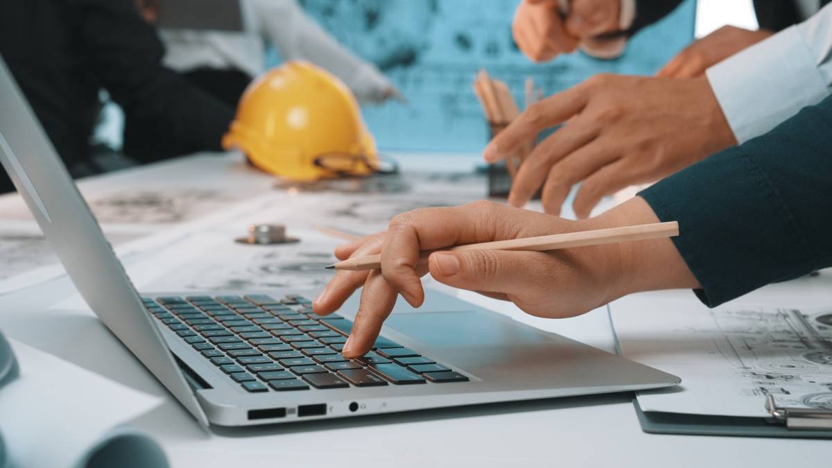 Contruction meeting on laptop around desk